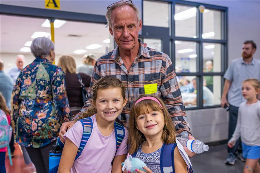 A family smiles at Winstead Elementary's Grandparents Breakfast